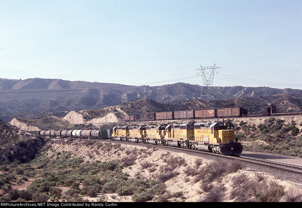 UP 3701 East with SP wb in background